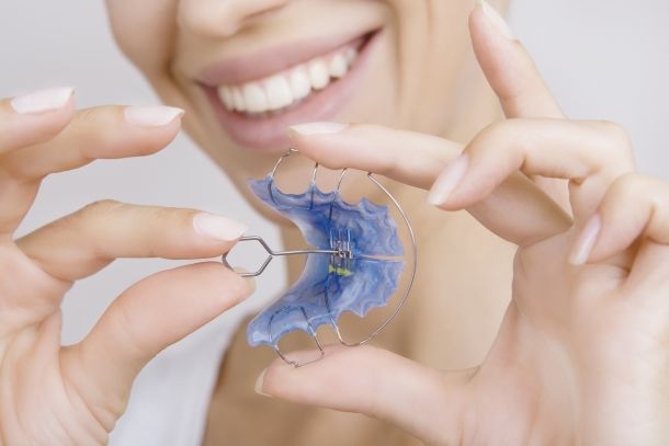 woman holding a retainer