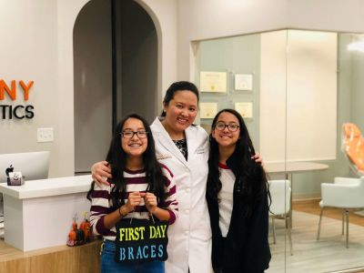 orthodontist with two patients with braces