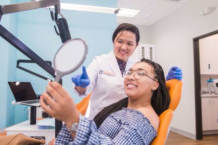 orthodontist looking at patient's smile