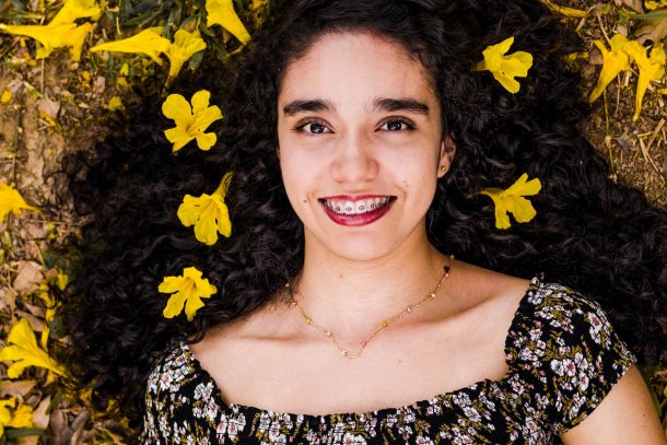 Girl lying on the ground with flowers in her hair